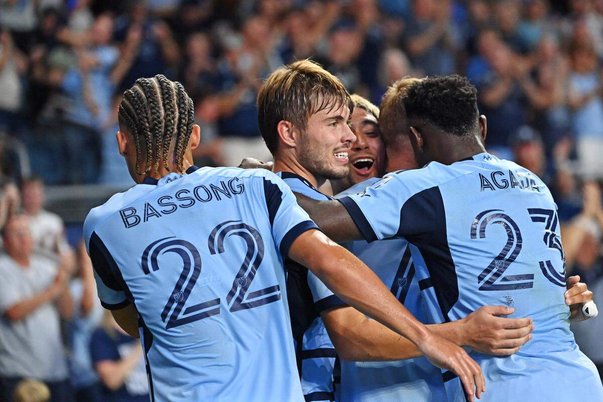 Sporting Kansas City teammates surround and congratulate midfielder Memo Rodriguez after his goal against FC Dallas at Children’s Mercy Park on Sunday evening.