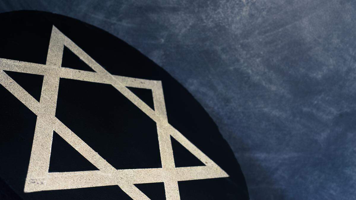 White Star of David on a black stone round. 