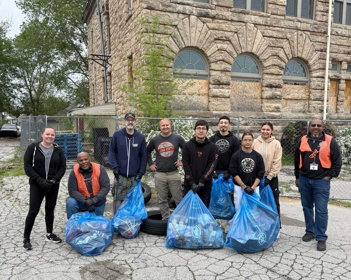 Amanda DeVriese-Sebilla (left) and volunteers at a community cleanup event outside the Franklin Center, an 1898 school that served Argentine before its incorporation into Kansas City, Kansas.