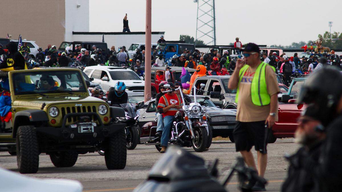 A parking lot overflows with vehicles getting ready for a parade honoring 3-year-old Tucker Langford on Oct. 11, 2025.