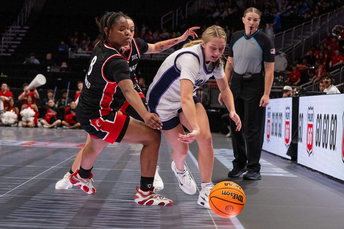 Kansas State guard Taryn Sides (11) dribbles past Cincinnati Bearcats defenders during the second half of the Wildcats’ first-round game vs. the Cincinnati Bearcats in the Big 12 Women’s Basketball Tournament.