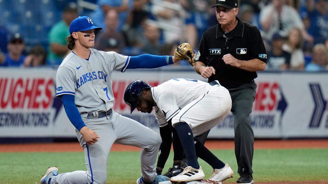 Kansas City Royals’ Bobby Witt Jr. (7) tags out Tampa Bay Rays’ Roman Quinn attempting to steal third base during the 10th inning of a baseball game Friday, Aug. 19, 2022, in St. Petersburg, Fla. Making the call is umpire Dan Iassogna. (AP Photo/Chris O’Meara)