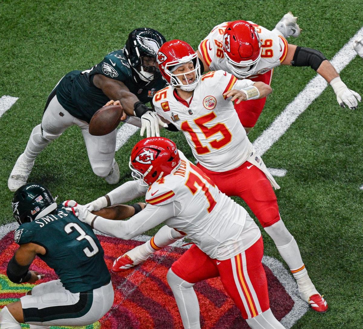 Philadelphia Eagles defensive tackle Milton Williams (93) strips the ball from Kansas City Chiefs quarterback Patrick Mahomes (15) in the fourth quarter during Super Bowl LIX on Sunday, Feb. 9, 2025, in New Orleans. The Eagles recovered the ball on the play.