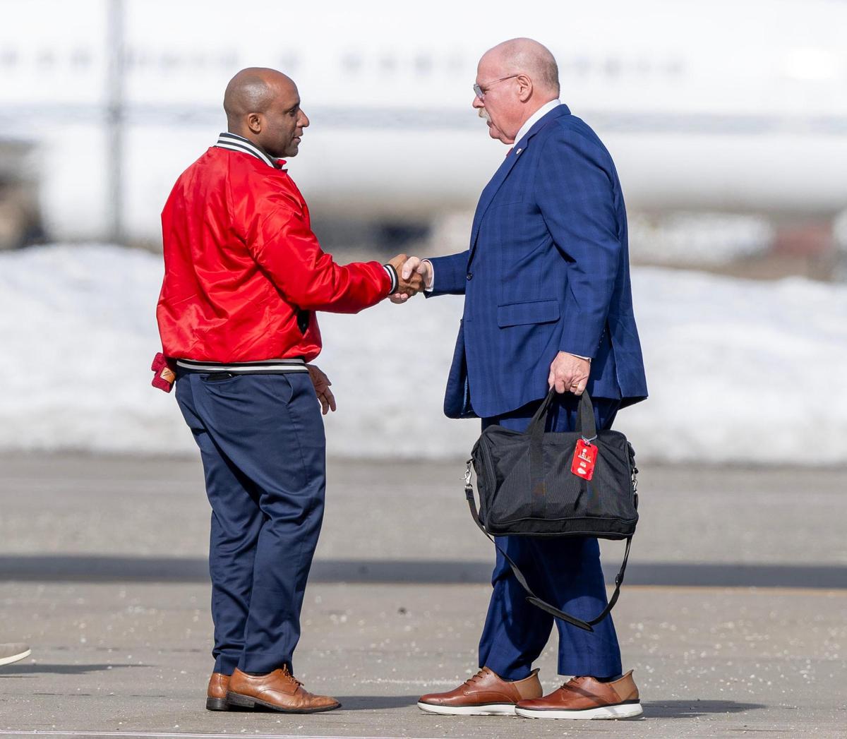 Kansas City Mayor Quinton Lucas shakes hands with Kansas City Chiefs head coach Andy Reid before he boards a plane at Kansas City International Airport for a flight to New Orleans for Super Bowl LIX on Sunday, Feb. 2, 2025.