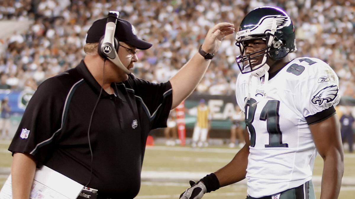 Philadelphia Eagles coach Andy Reid, left, has a word with receiver Terrell Owens (81) in the first quarter against the Cincinnati Bengals, Friday, Aug. 26, 2005, in Philadelphia. (AP Photo/Rusty Kennedy)