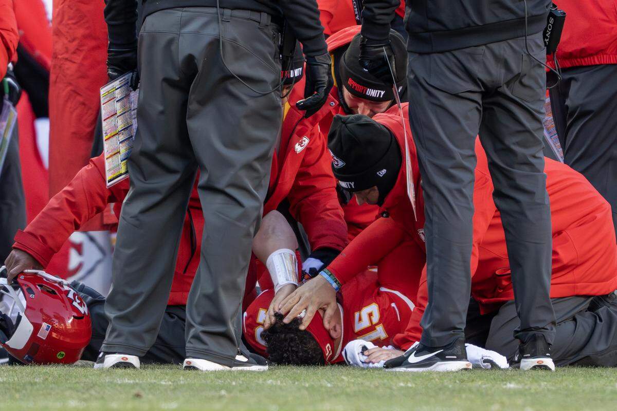 Kansas City Chiefs quarterback Patrick Mahomes (15) puts his hands on his face after being injured in the fourth quarter playing the Los Angeles Chargers on Sunday, Dec. 14, 2025, at GEHA Field at Arrowhead Stadium in Kansas City.