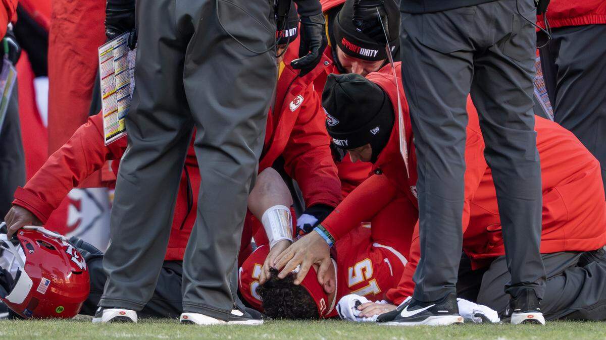 Kansas City Chiefs quarterback Patrick Mahomes (15) puts his hands on his face after being injured in the fourth quarter playing the Los Angeles Chargers on Sunday, Dec. 14, 2025, at GEHA Field at Arrowhead Stadium in Kansas City.