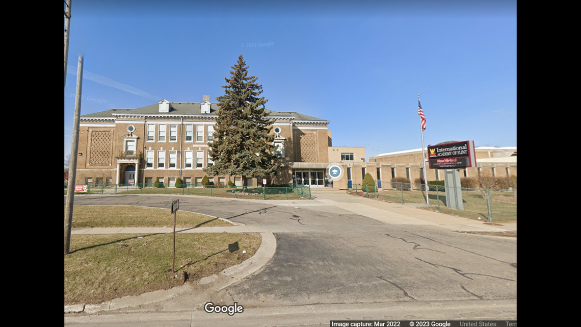 A mother shot another parent outside a school in Flint, Michigan, while picking up her child, officials say.