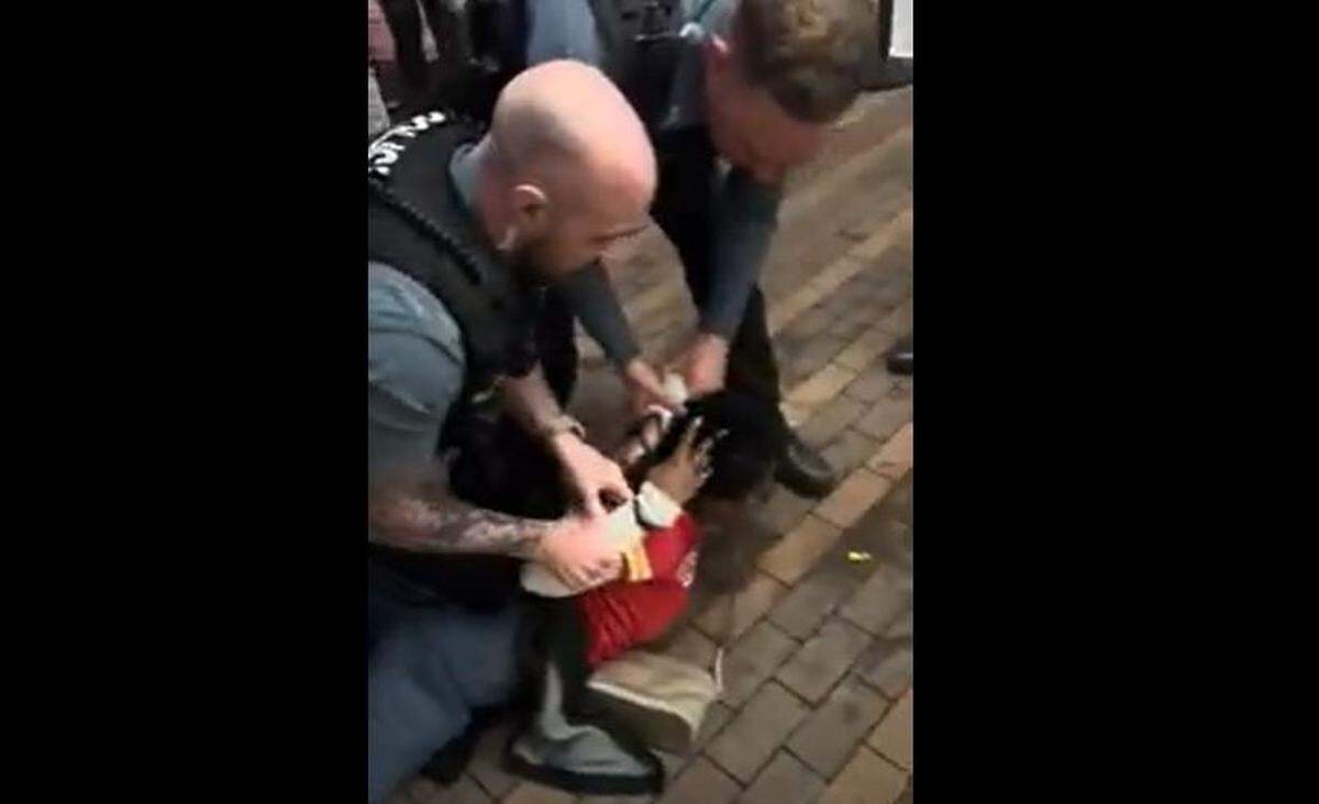 An image taken from a bystander’s video shows Kansas City police arresting a woman at the Power & Light District.
