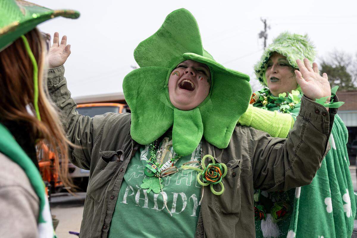 Sabrina Gerdes smiles as April Coleman adjusts her shamrock hat during the St. Patrick's Day parade on Tuesday, March 17, 2026, in Kansas City.