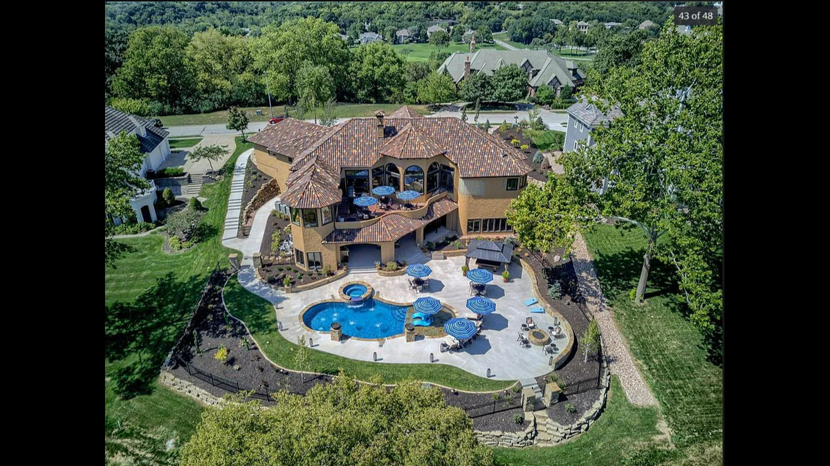 An aerial view of the house at 6521 Ridge Road in Parkville. The pool is custom-made and features waterfalls, fountains, a sun deck and jacuzzi.
