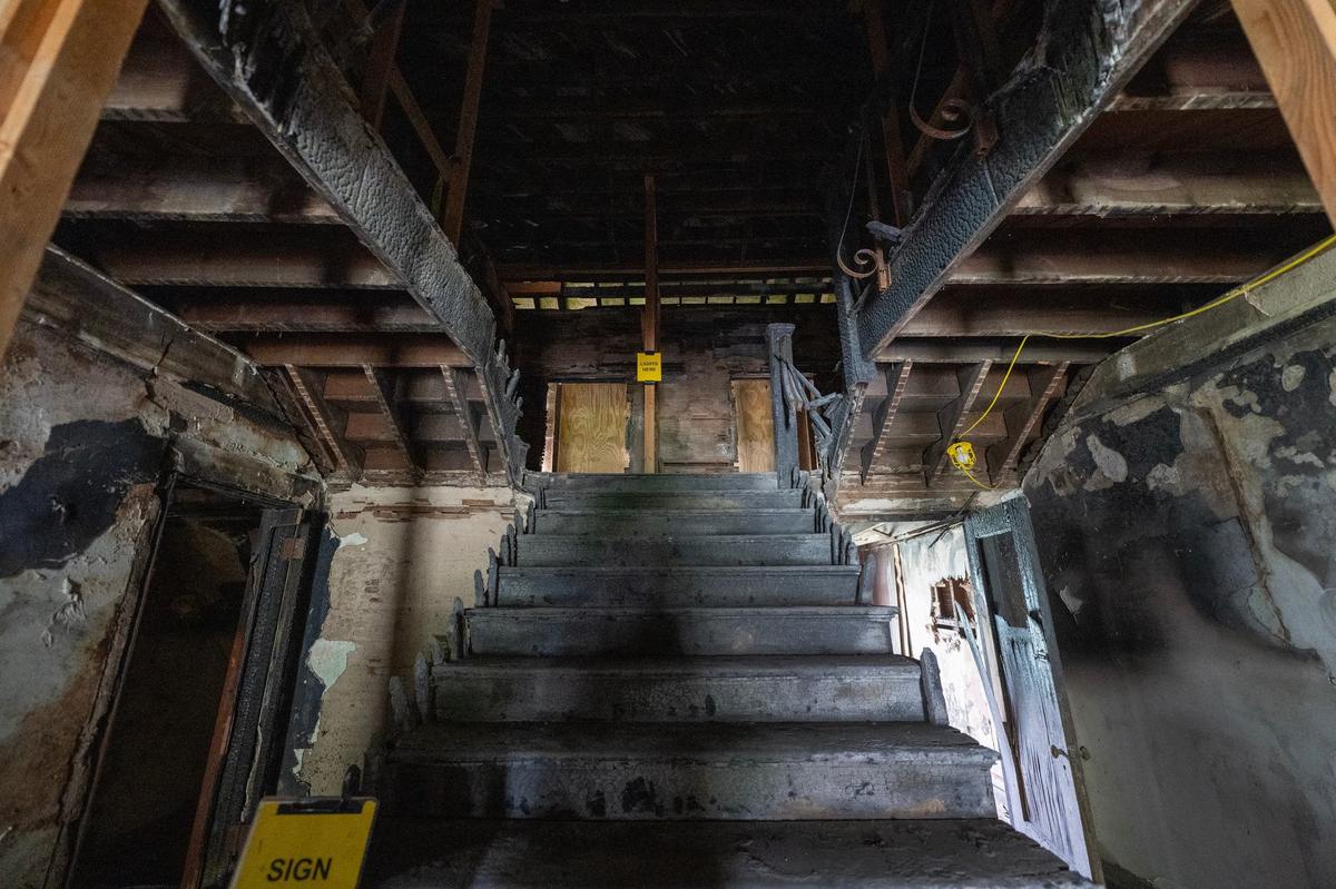 A 2018 fire, suspected to be arson, engulfed the home that once belonged to famed Negro Leagues pitcher Satchel Paige. Six years later, the central staircase remains blackened and charred.