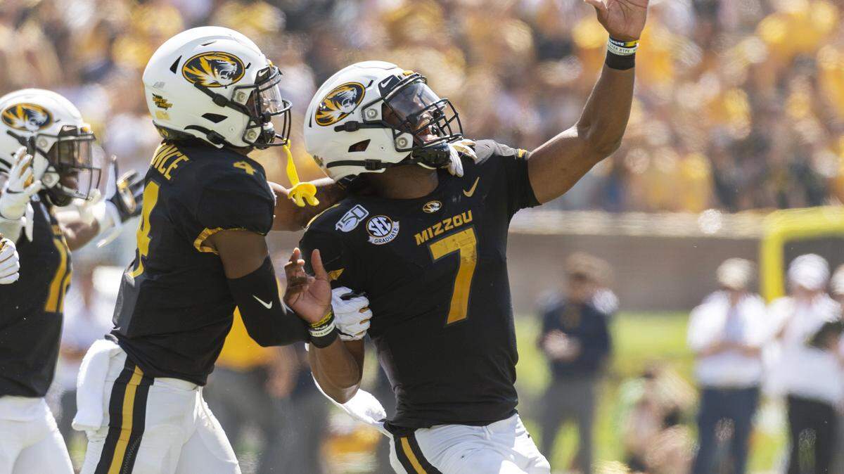 Missouri quarterback Kelly Bryant, right, celebrates a touchdown pass with teammate Jonathan Nance, left, during the first half of an NCAA college football game against West Virginia Saturday, Sept. 7, 2019, in Columbia, Mo. (AP Photo/L.G. Patterson)