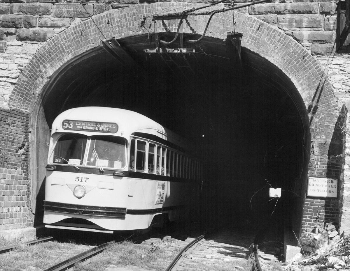 A streetcar emerges from the 8th Street tunnel in the mid-20th century.