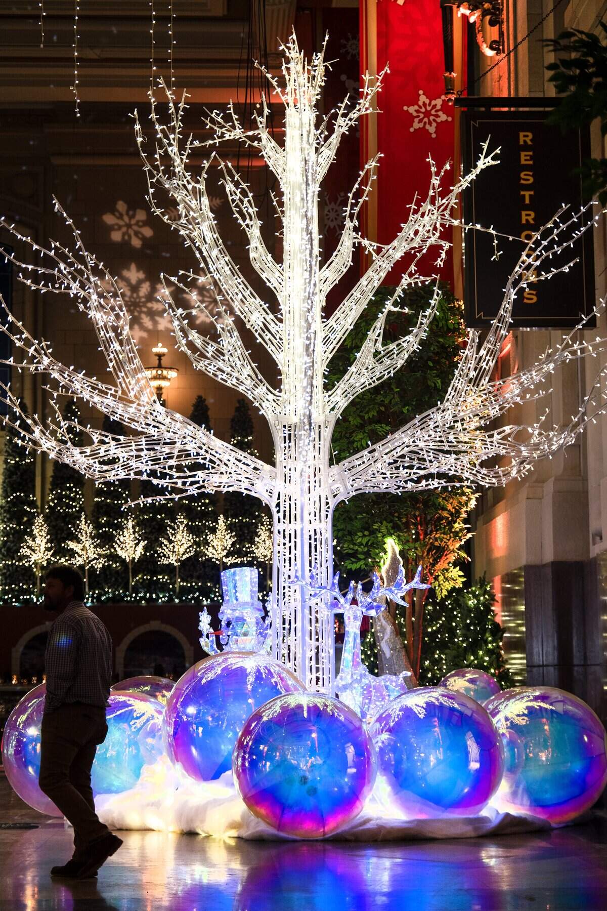 The 20-foot tall enchant tree is illuminated as final touches were being put on “Holiday Reflections” at Union Station on Thursday, November 20, 2025, in Kansas City. The exhibit opens Friday, November 21 and runs through January 4, 2026.