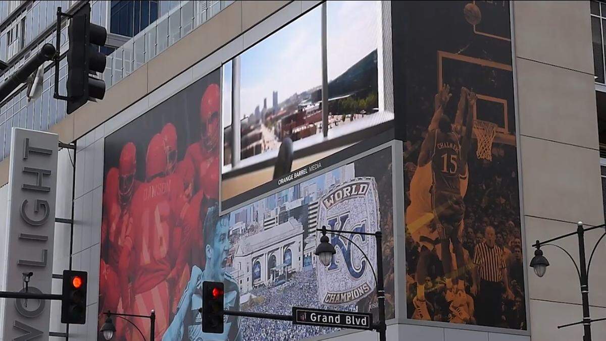 A photo of Mario Chalmers' three-pointer in the 2008 NCAA championship game is displayed on the Grand Boulevard side of the Two Light Luxury Apartments building in Kansas City.