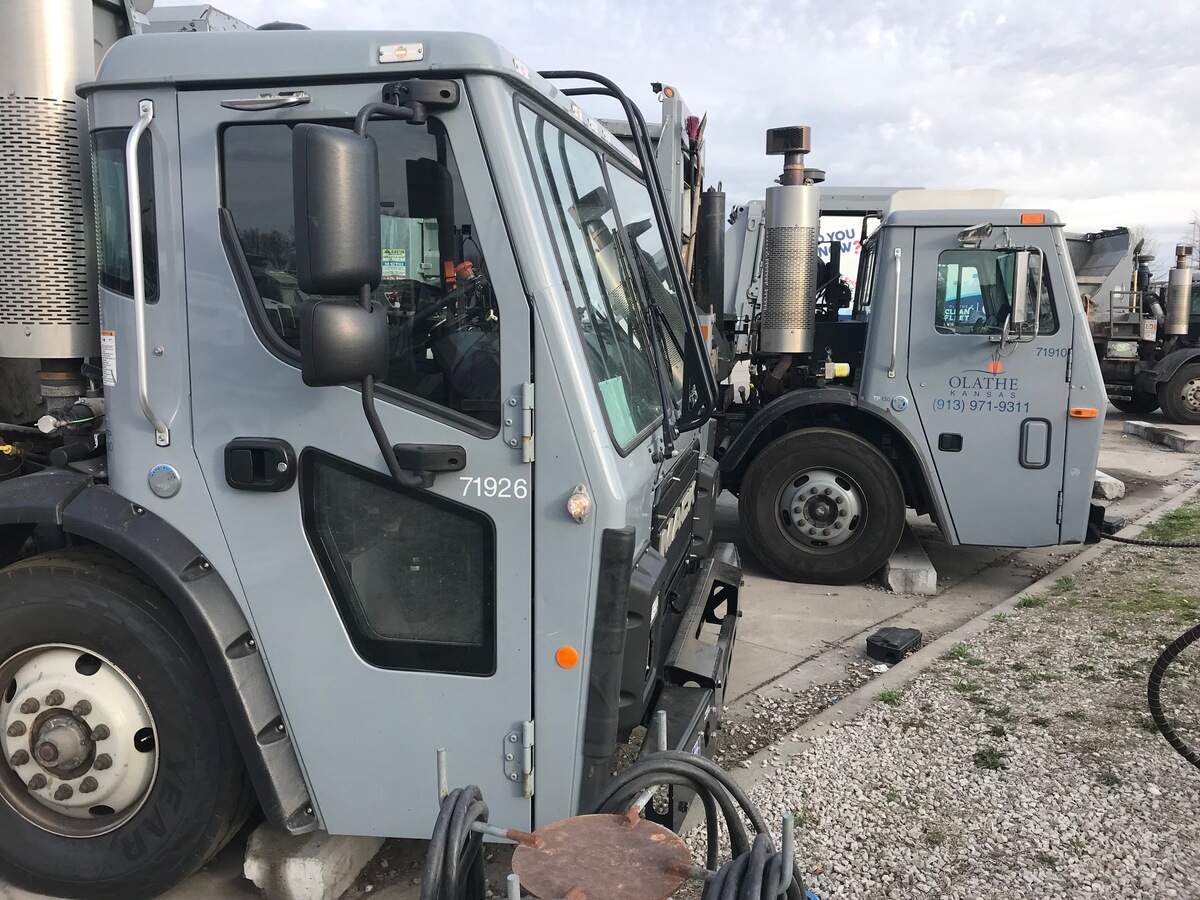 Several trash trucks are seen behind the city of Olathe’s Public Works headquarters on Monday, April 10, 2023.