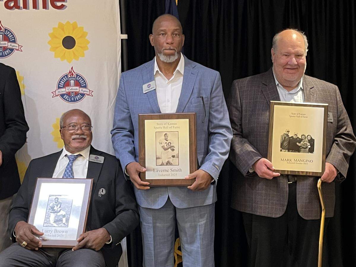Former Kansas State running back Larry Brown (left), Kansas running back Laverne Smith (middle) and Jayhawks football coach Mark Mangino at the 2025 Kansas Sports Hall of Fame at Washburn University in August 2025.
