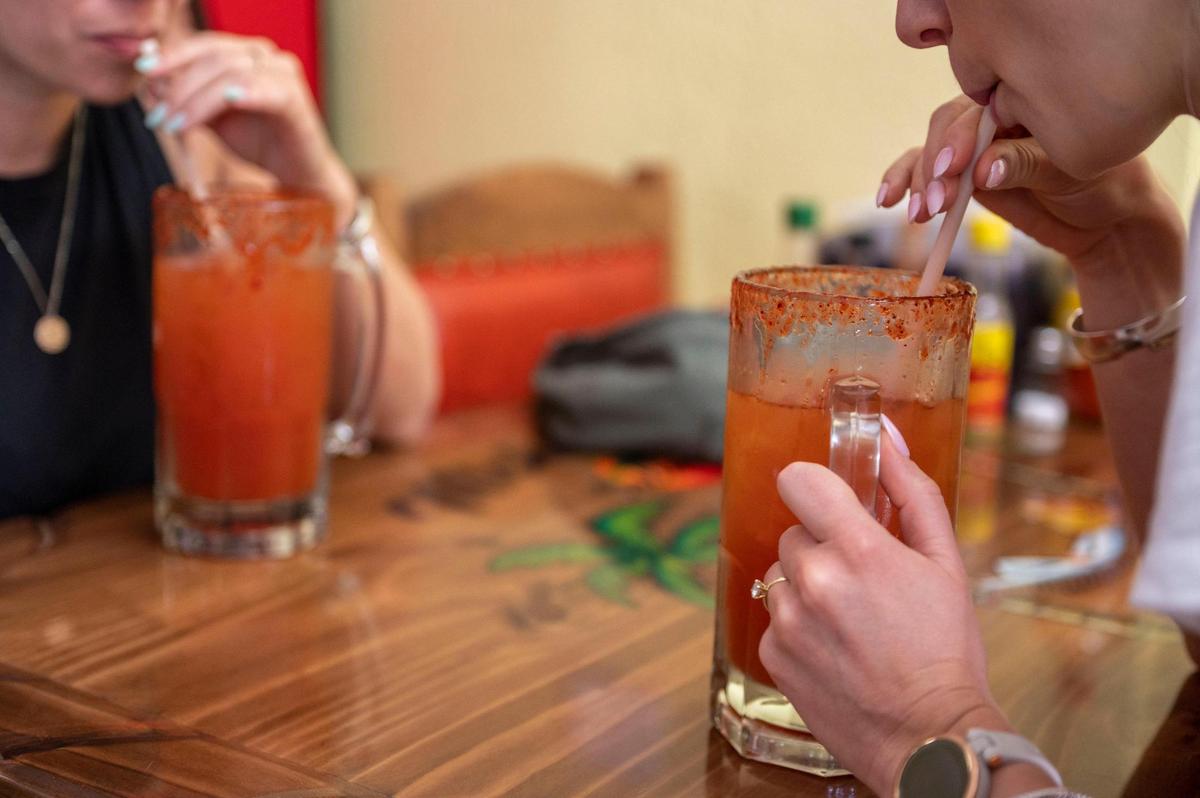 Customers drink micheladas at Micheladas Culiacán. The drink is popular throughout Mexico, but is especially common on the beaches. It’s like a beer cocktail, with tomato juice, salt and lemon.