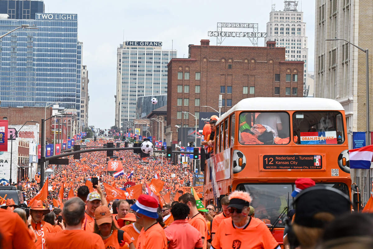 The ‘Oranje bus’ processes down Grand Boulevard as part of the Netherlands Orange Walk from Kansas City’s Power & Light District to FIFA Fan Fest on June 25, 2026.