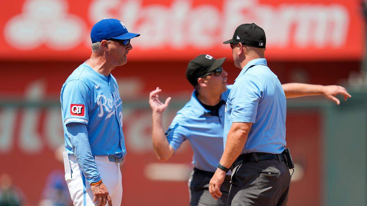 Kansas City Royals manager Matt Quatraro (33) is ejected after arguing with umpires Paul Clemons (104) and Scott Barry (87) during the sixth inning against the New York Yankees at Kauffman Stadium on June 13, 2024.