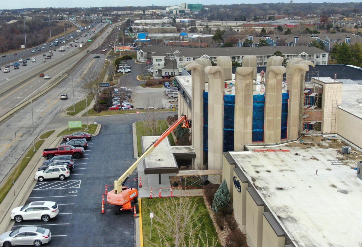 A crew from MTS Contracting, Inc., of North Kansas City, works on the iconic curved concrete pillars at 8101 Lenexa Drive in Lenexa on Thursday, Jan. 2.