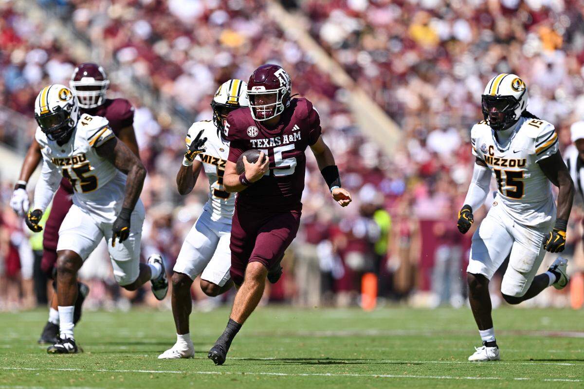 Texas A&M quarterback Conner Weigman (No. 15) takes off for a big gain against the Missouri Tigers during Saturday’s SEC football game at Kyle Field in College Station, Texas.
