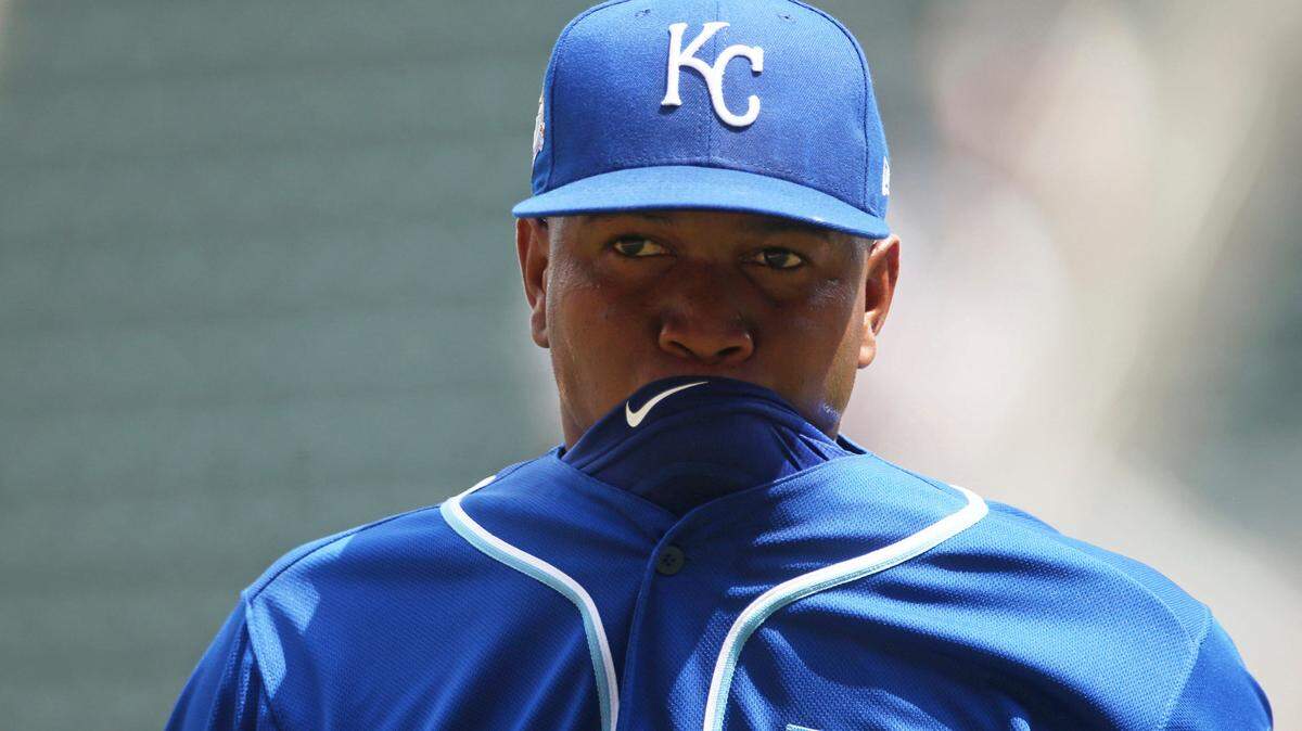 Royals reliever Enny Romero bites his jersey on the way to the dugout after the sixth inning Wednesday.