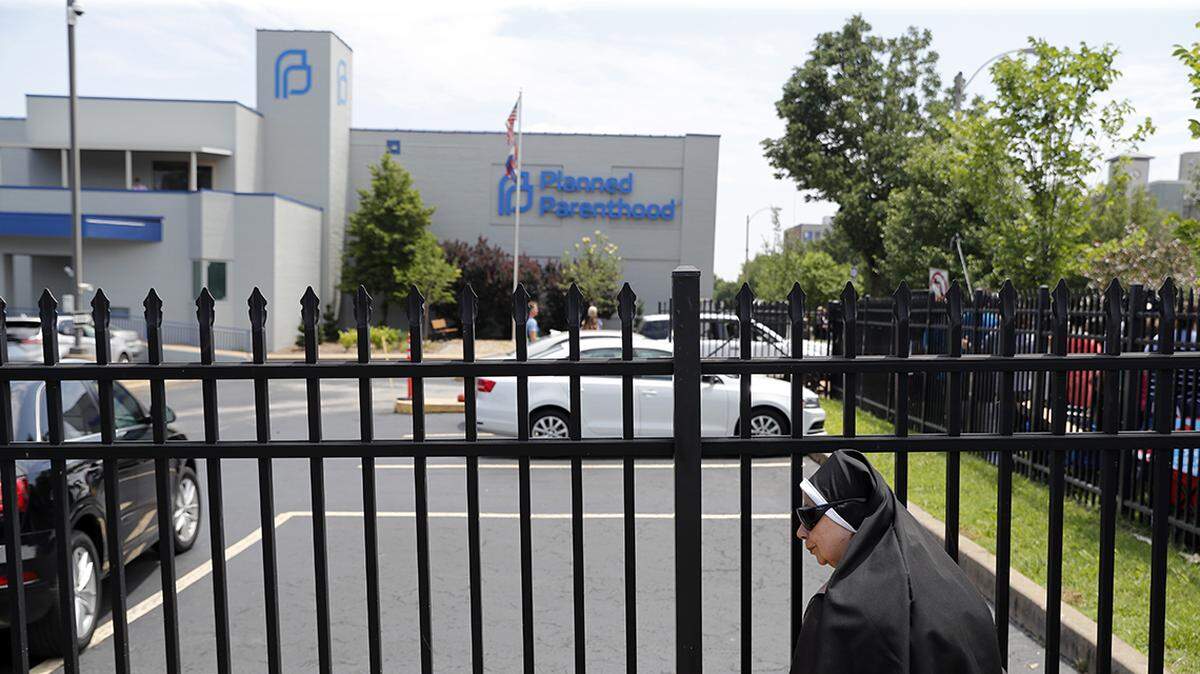 Sister Benedicta, a Carmelite nun, stood at a gate outside the Planned Parenthood clinic in St. Louis during an anti-abortion rally Tuesday, June 4, 2019.