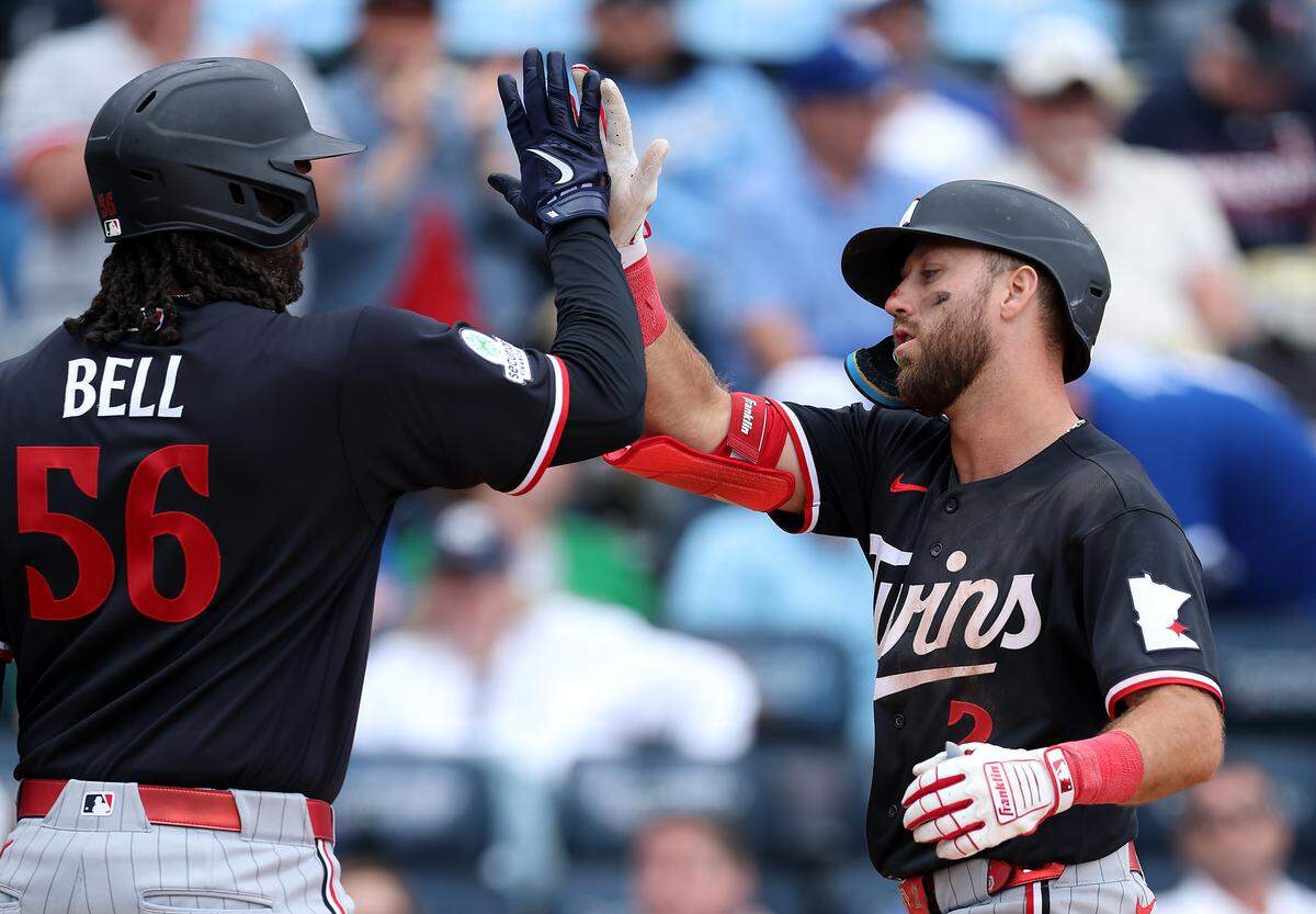 Minnesota Twins second baseman Kody Clemens, right, is congratulated by teammate Josh Bell after hitting a ninth-inning home run off Royals reliever Steven Cruz at Kauffman Stadium on Thursday, April 2, 2026 in Kansas City.