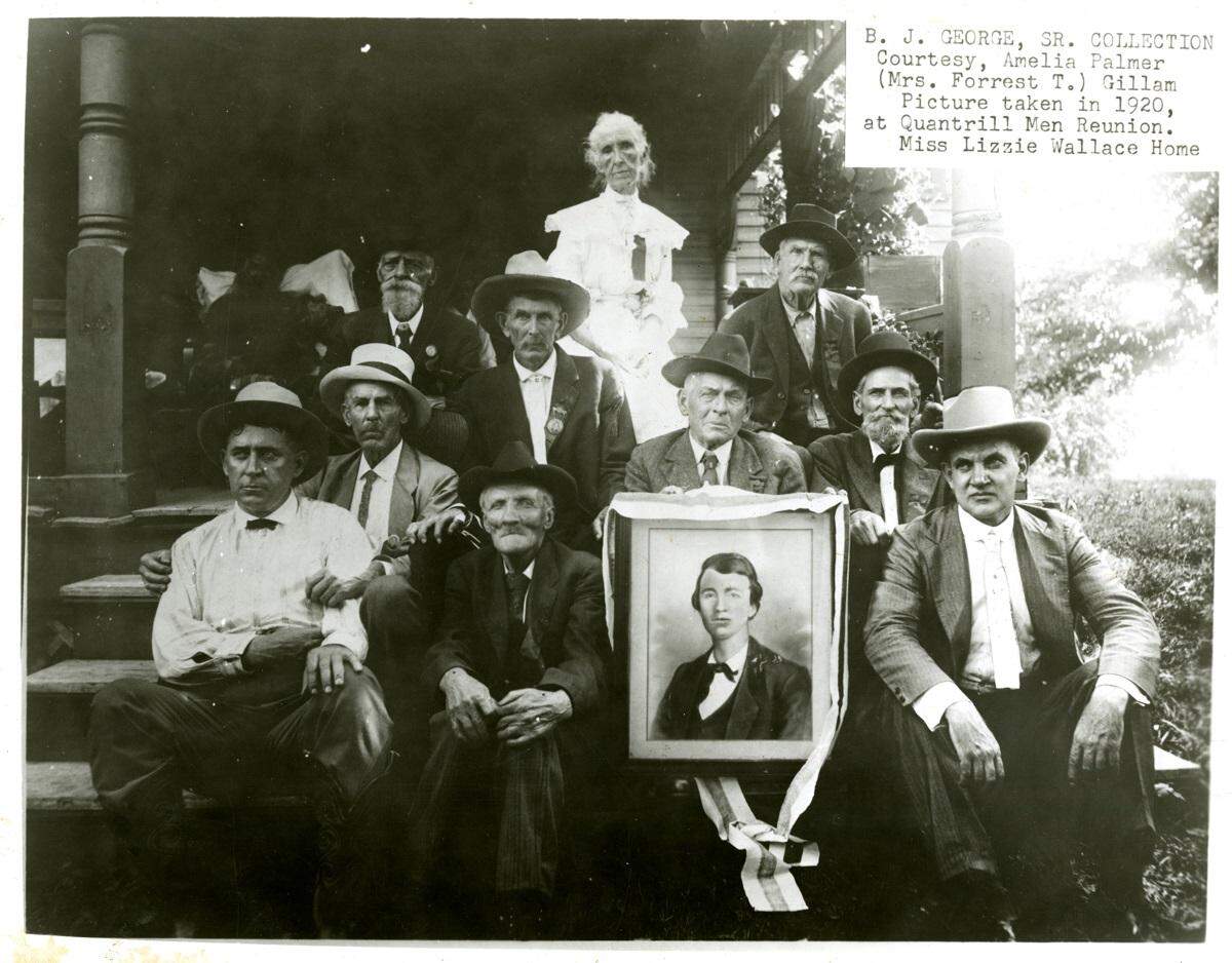 Attendees of the 1920 reunion at Wallace Grove with a picture of a young Quantrill. A special guest was Jesse James Jr. (front right), son of the famous outlaw. Lizzie “Aunt E” Wallace is back-row center.