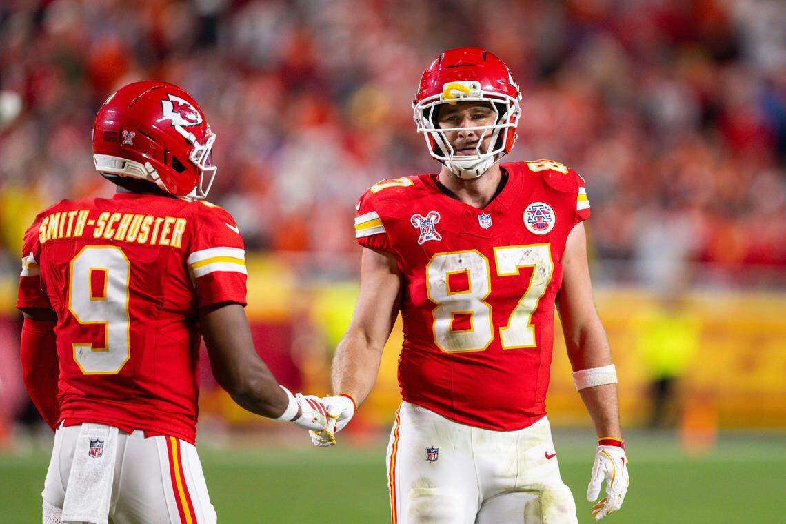 Kansas City Chiefs tight end Travis Kelce (87) shakes hands with Kansas City Chiefs wide receiver Juju Smith-Schuster (9) after the Chiefs turnover the ball on downs late in the second half of the Chiefs game vs. the Denver Broncos on Thursday, December 25, 2025, at GEHA Field at Arrowhead Stadium.