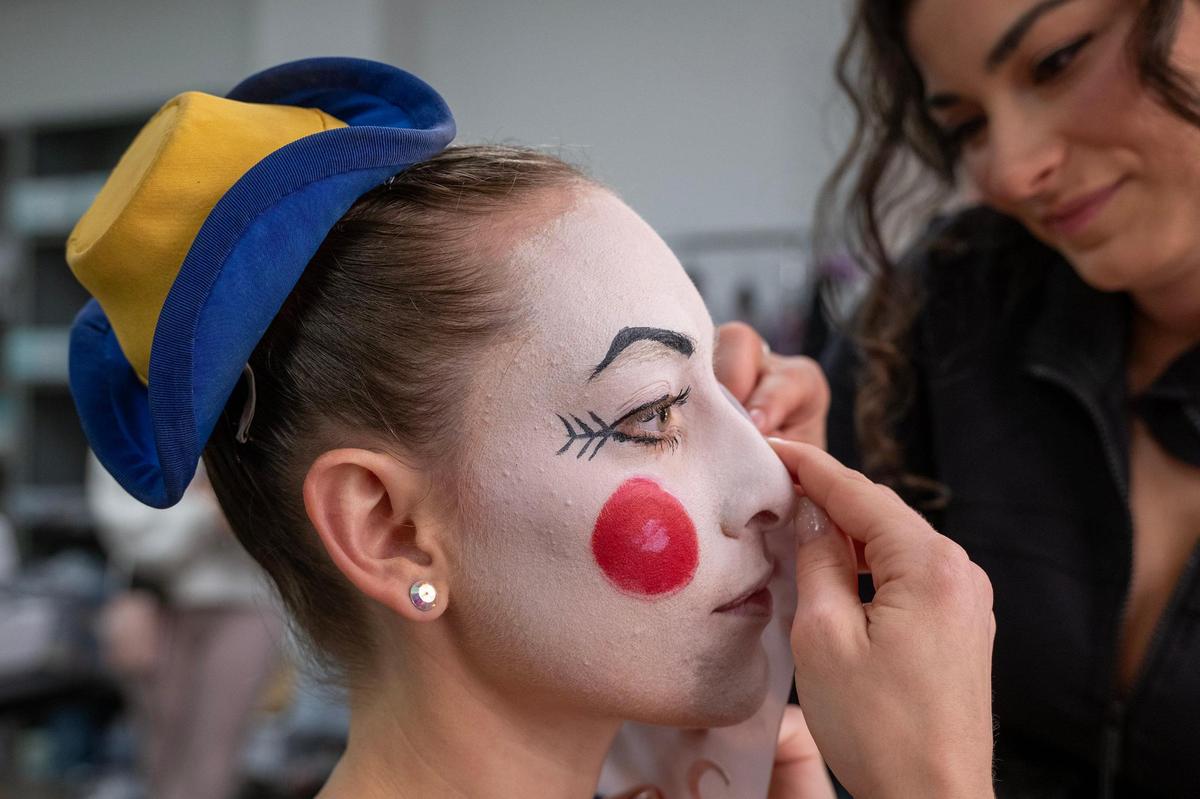 Many of the dancers in “The Nutcracker” must appear nearly identical so a plastic template aids in forming identical shapes on each dancer’s face.