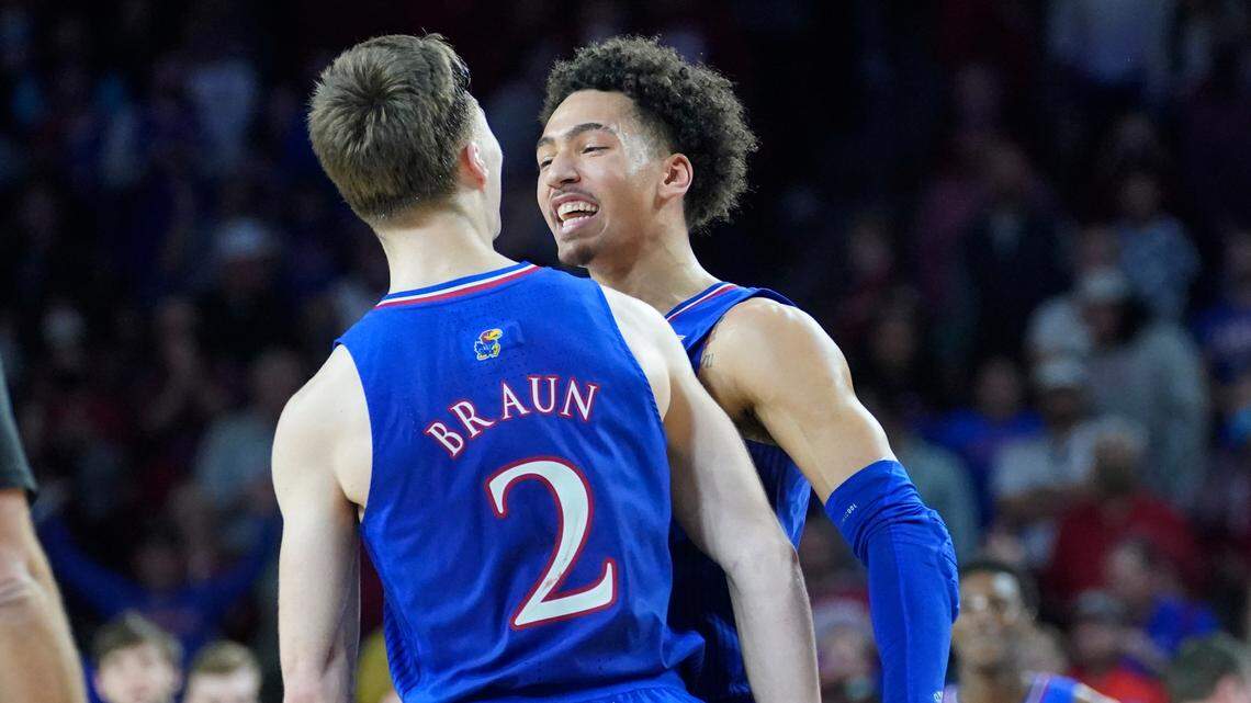 Kansas forward Jalen Wilson, right, celebrates with teammate Christian Braun (2) in the second half of an NCAA college basketball game against Oklahoma, Tuesday, Jan. 18, 2022, in Norman, Okla. (AP Photo/Sue Ogrocki)