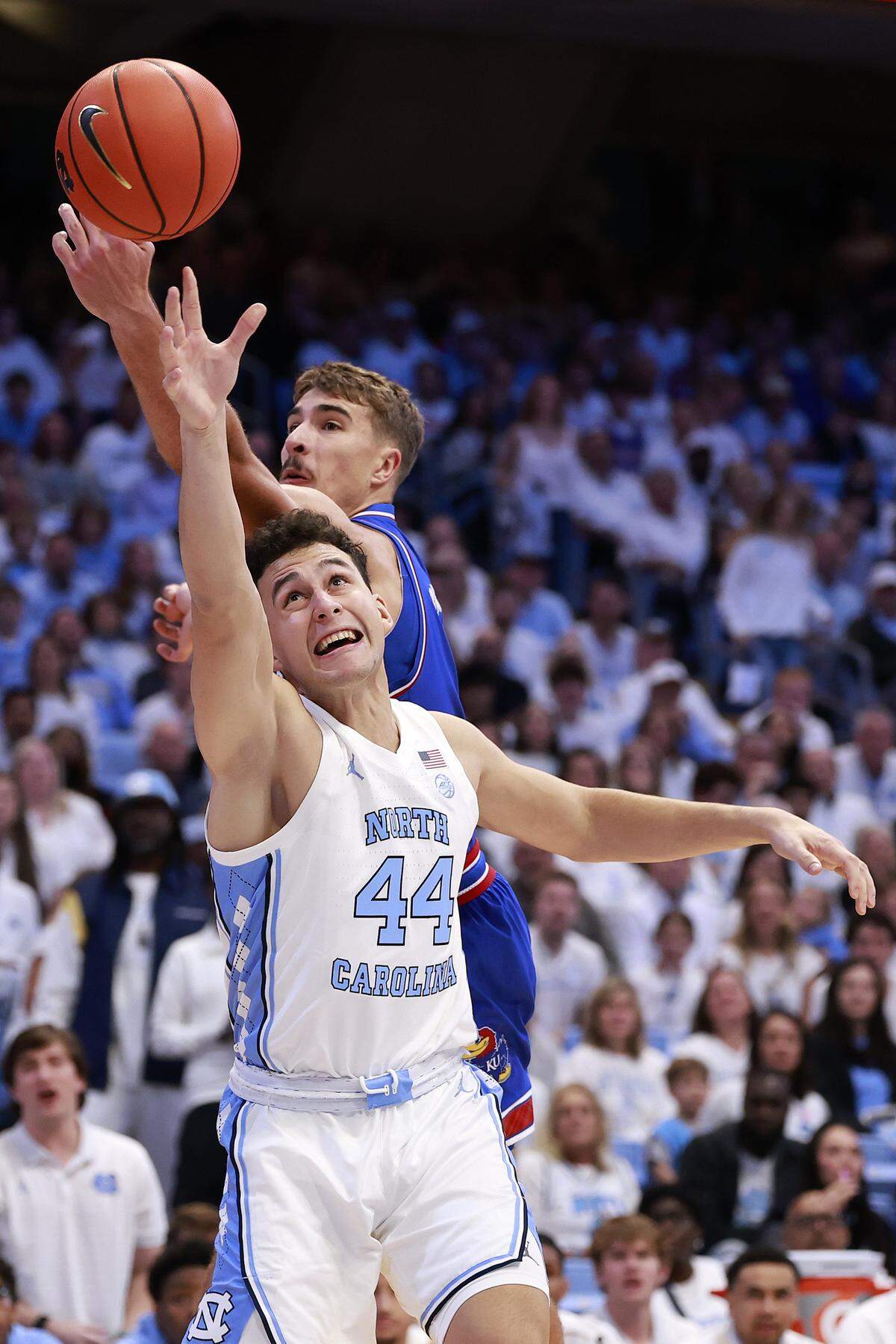 North Carolina’s Luka Bogavac (No. 44) battles Kansas’ Kohl Rosario for a rebound during a men’s college basketball game at the Dean E. Smith Center in Chapel Hill, N.C., on Friday, Nov. 7, 2025.