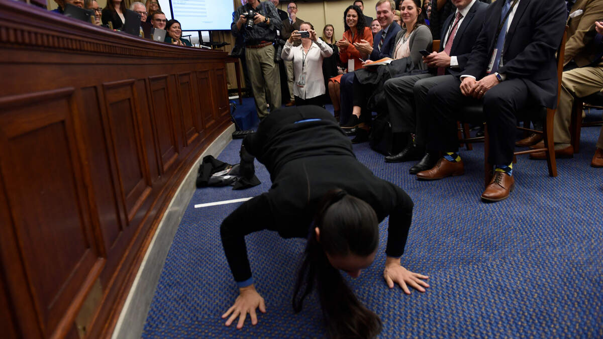 Rep.-elect Sharice Davids, D-Kan., did pushups as she prepared to draw her number Friday during the member-elect room lottery draw on Capitol Hill. Davids drew 64 out of 85, which determines the order in which she gets to select her new Capitol Hill office.