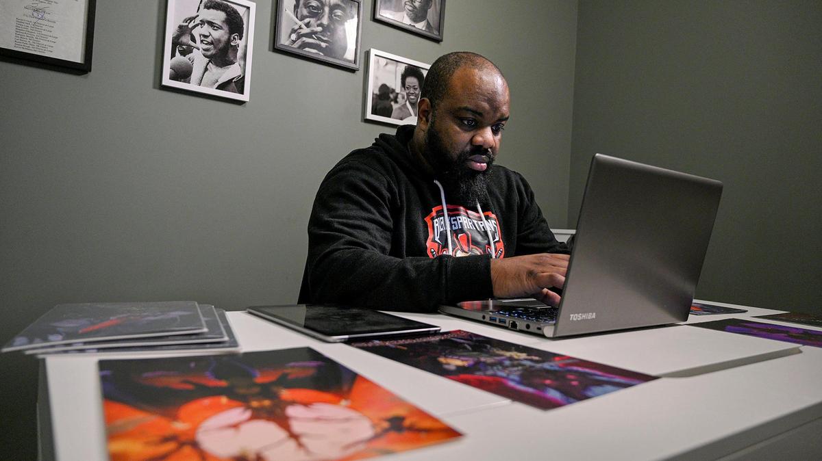 Brandon Calloway works on a story for his “Black Spartans” manga series in his 31st Street office.