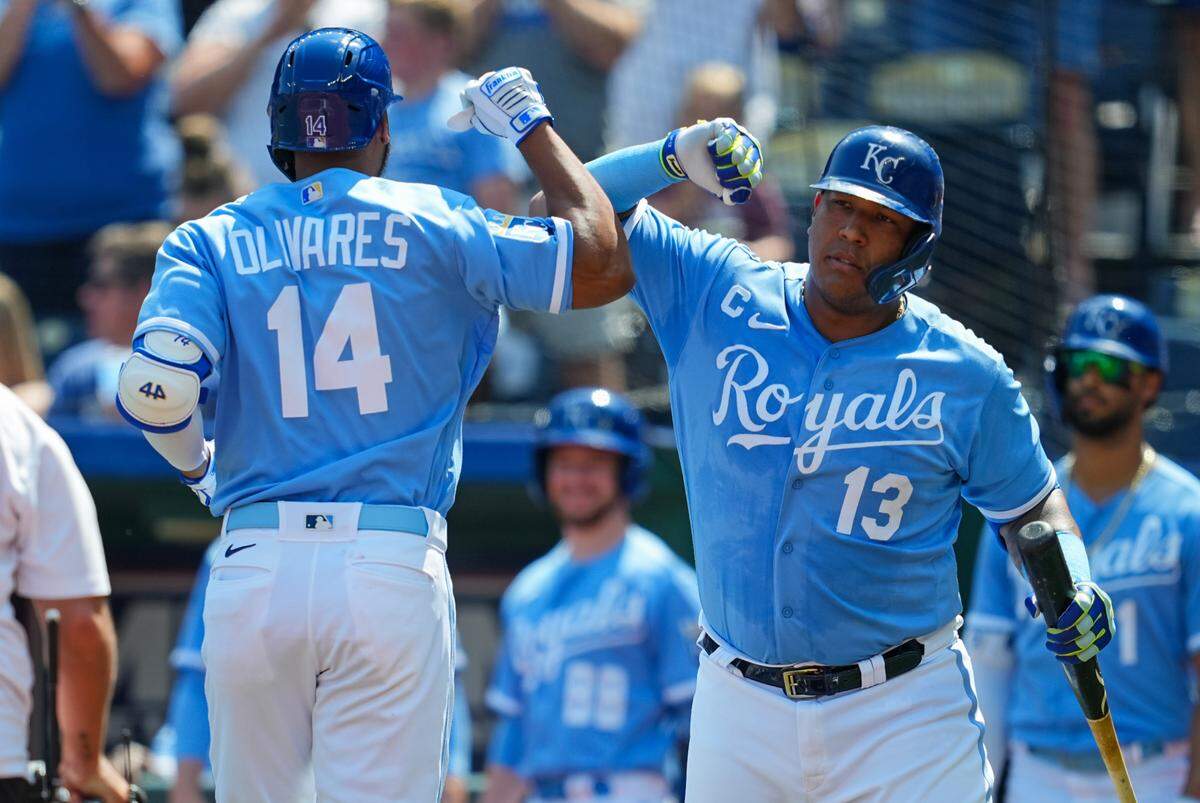 Royals left fielder Edward Olivares (No. 14) celebrates with teammate Salvador Perez after hitting a first-inning home run against the Chicago White Sox on Sunday at Kauffman Stadium.