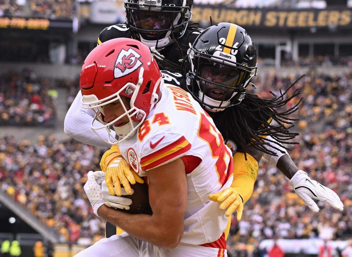 Kansas City Chiefs wide receiver Justin Watson cradles a touchdown pass during an NFL Week 17 game against the Steelers at Acrisure Stadium in Pittsburgh on Wednesday, Dec 25, 2024.