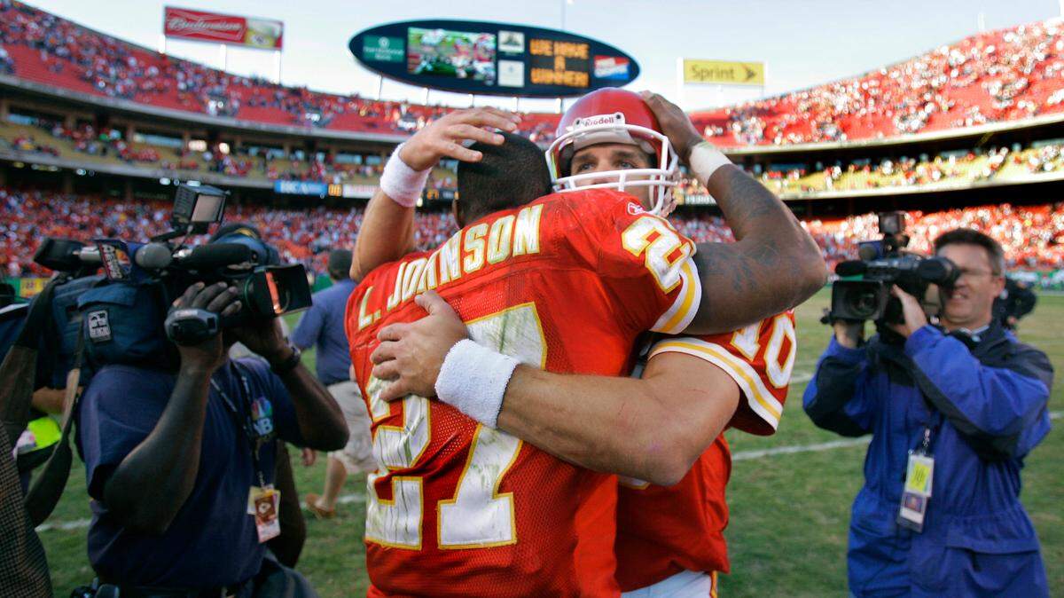 Kansas City Chiefs quarterback Trent Green, center, hugged teammate Larry Johnson after Johnson scored the winning touchdown on the game’s final play against the Oakland Raiders Sunday afternoon at Arrowhead Stadium. The Chiefs won 27-23.