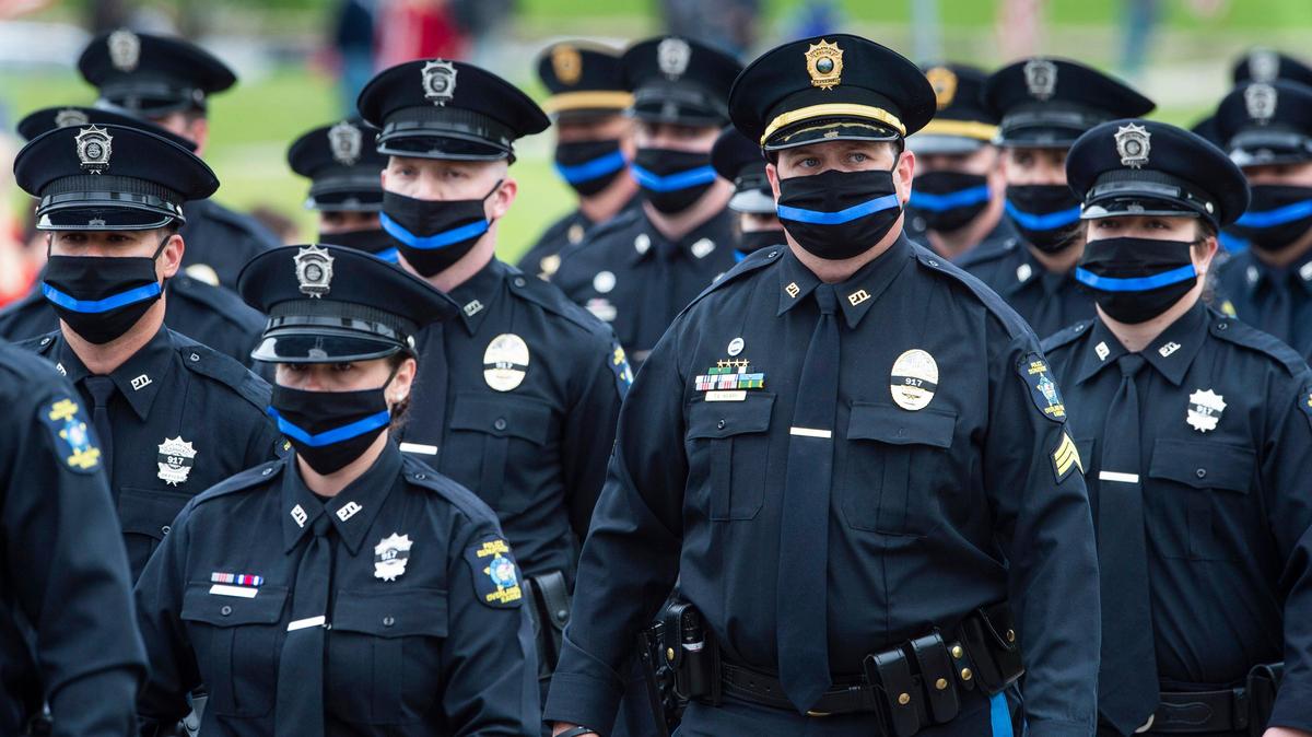 Overland Park police officers walked in the funeral procession of OPPD officer Mike Mosher Wednesday. The funeral was attended by members of his family and other police officers under pandemic social distancing guidelines. Mosher was killed in the line of duty May 3.
