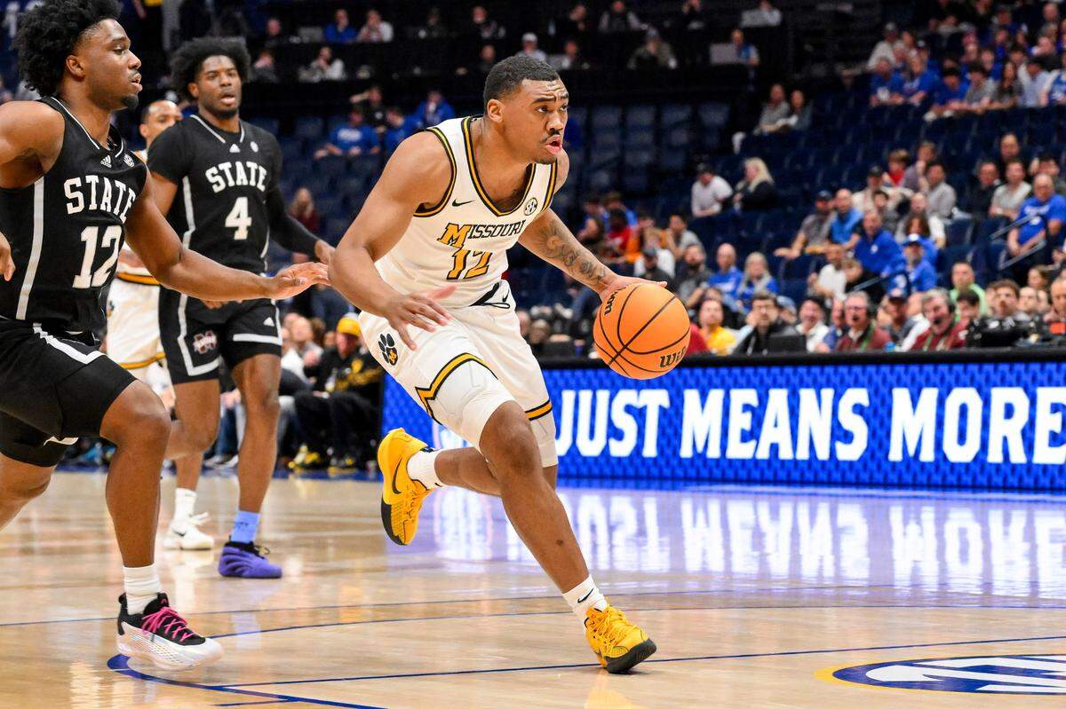 Missouri Tigers guard Tony Perkins (12) drives to the basket against the Mississippi State Bulldogs during the first half at Bridgestone Arena on March 13, 2025.