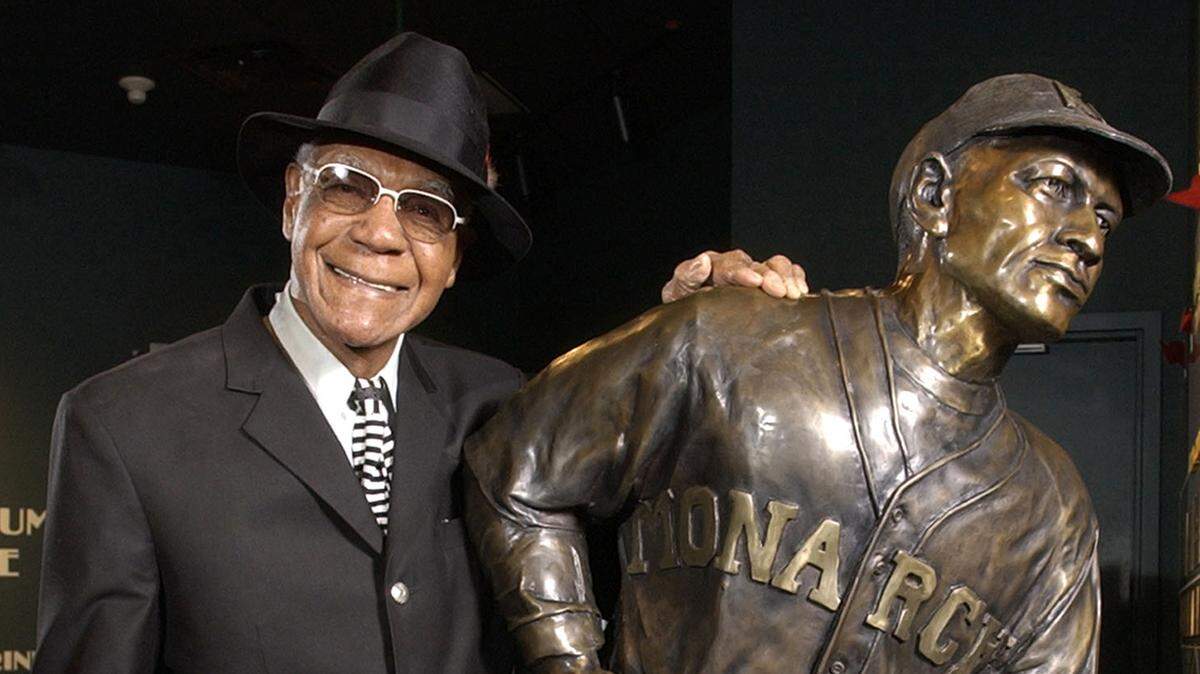 In this Feb. 11, 2005 photo, Buck O’Neil stands with a statue of himself in the Negro League Baseball Museum in Kansas City.