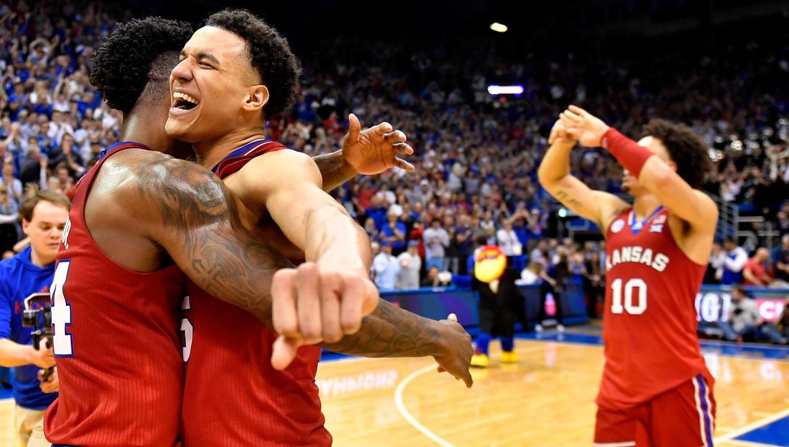 KU teammates KJ Adams (far left) and Kevin McCullar embrace after the Jayhawks clinched a share of the Big 12 Conference title by defeating Texas Tech on Feb. 28, 2023, at Allen Fieldhouse.