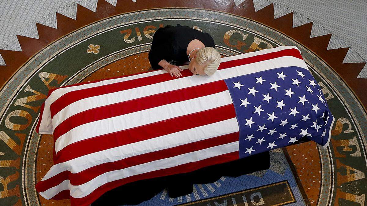 Cindy McCain, wife of the late Sen. John McCain, touches her husband’s coffin during his memorial service Wednesday.