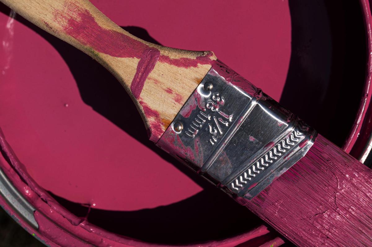 Jasmine Ali’s paint brush sits atop of her paint can on Friday, Sept. 15, 2023, at the Riverfront Heritage Trial in Kansas City. The murals were commissioned by Port KC and created by local and national artists.