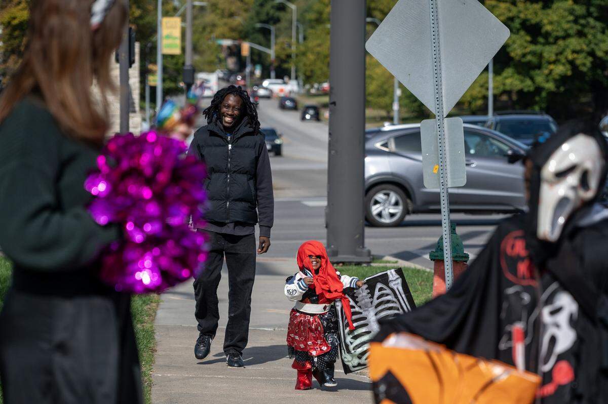 Children in costumes walk up to Russell Stover's headquarters to receive candy during the company's annual Halloween giveaway on Friday, Oct. 31, 2025, in Kansas City.