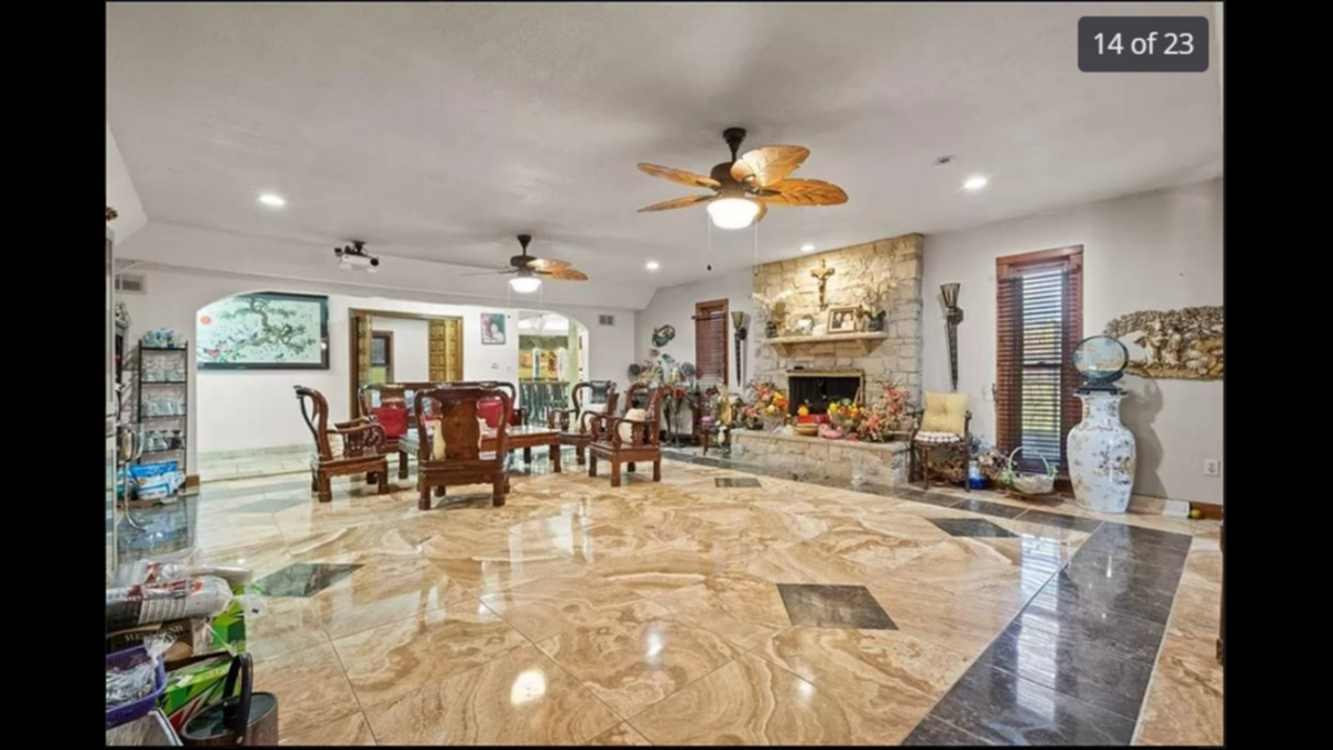 The dining room inside the house at 5401 Phelps Road in Kansas City. The floor is tiled and the fireplace in the room works with firewood.