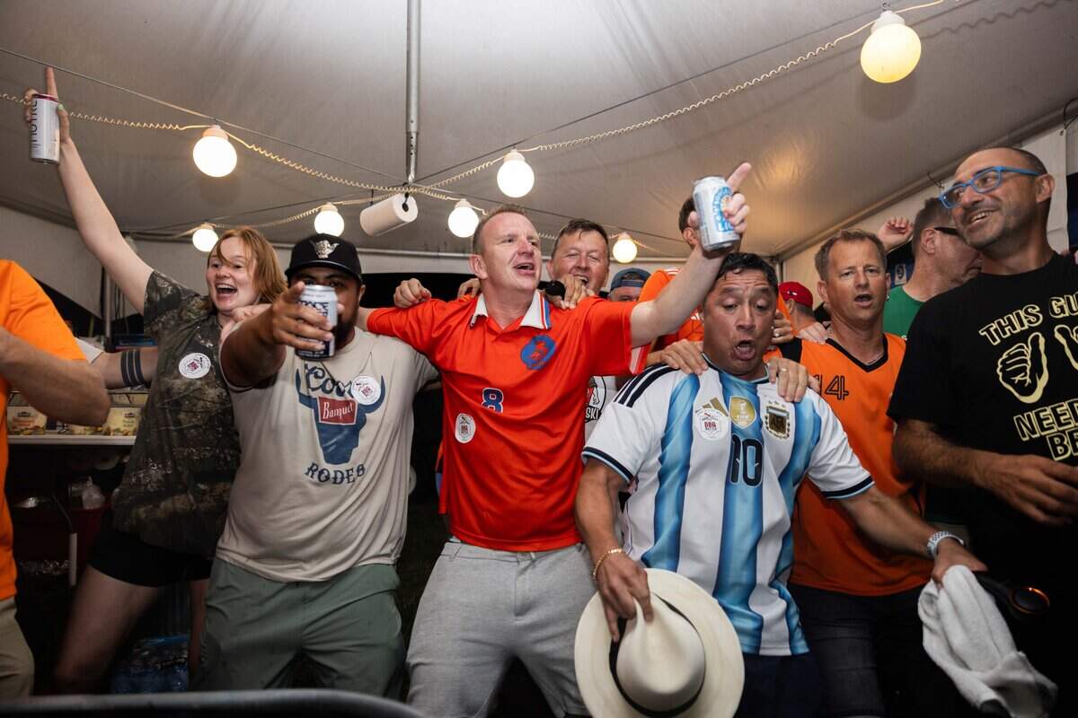 Family and friends of The Pig Lebowski team, along with Dutch visitors dance to "Links Rechts" at The Great Lenexa BBQ Battle on Friday, June 26, 2026.