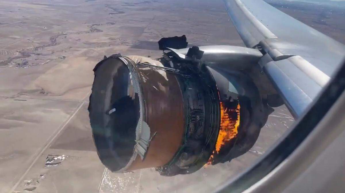 In this file photo taken from video, the engine of United Airlines Flight 328 is on fire after experiencing “a right-engine failure” shortly after takeoff from Denver International Airport, Saturday, Feb. 20, 2021, in Denver, Colo. Two passengers who were on board the United Airlines airplane that had to make an emergency landing are suing the company in separate suits filed Friday, April 16 in Chicago, where United is based.
